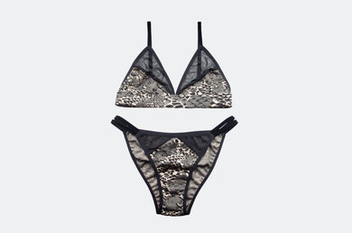 Black and beige leopard print lingerie set on a light gray background